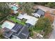 Aerial view of property showcasing house, pool, and solar panels at 1217 E Flora St, Tampa, FL 33604