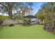 Landscaped backyard featuring a pergola, fire pit, and hammock at 1217 E Flora St, Tampa, FL 33604