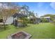 Expansive backyard with pergola, fire pit, and lush greenery at 1217 E Flora St, Tampa, FL 33604