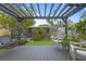 Relaxing backyard patio with pergola, seating area, and lush landscaping at 1217 E Flora St, Tampa, FL 33604