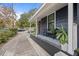 Inviting front porch with a bench and potted plants at 1217 E Flora St, Tampa, FL 33604