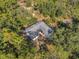 Aerial view of a house nestled in a wooded area at 12240 Eakin St, Weeki Wachee, FL 34614