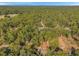 Aerial view of a house in a wooded area near a road at 12240 Eakin St, Weeki Wachee, FL 34614