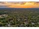 Aerial view of a community at sunset, showcasing homes and trees at 12240 Eakin St, Weeki Wachee, FL 34614