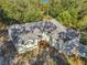 Aerial view showcasing the house's layout and surrounding trees at 12240 Eakin St, Weeki Wachee, FL 34614