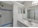 Clean bathroom with shower, single sink, and additional mirror at 12240 Eakin St, Weeki Wachee, FL 34614