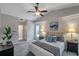 Spacious bedroom with ensuite bathroom access and ceiling fan at 12240 Eakin St, Weeki Wachee, FL 34614