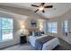 Bright bedroom with high ceilings, ceiling fan, and ample natural light at 12240 Eakin St, Weeki Wachee, FL 34614