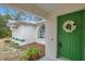 Green front door with a wreath, and landscaping at 12240 Eakin St, Weeki Wachee, FL 34614