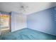 Bedroom with white closet doors and teal carpet at 13000 Club Dr, Hudson, FL 34667