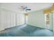 Spacious bedroom with teal carpet and ample closet space at 13000 Club Dr, Hudson, FL 34667