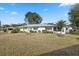 Back of house with fenced yard and screened patio at 13000 Club Dr, Hudson, FL 34667