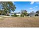 Ranch-style home with a large yard and driveway at 13000 Club Dr, Hudson, FL 34667