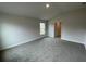 Spacious bedroom with carpeted floor and large window at 13299 Ogden Glade Rd, Dade City, FL 33525