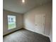 Cozy bedroom with carpeted floor and window at 13299 Ogden Glade Rd, Dade City, FL 33525