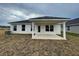 House exterior featuring covered patio and AC unit at 13299 Ogden Glade Rd, Dade City, FL 33525