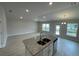 Kitchen with island, granite counters and stainless steel appliances at 13299 Ogden Glade Rd, Dade City, FL 33525