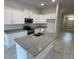 Modern kitchen with white cabinets and granite countertops at 13299 Ogden Glade Rd, Dade City, FL 33525