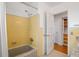 Bathroom with yellow tile, shower, and tub at 1338 Whitacre Dr, Clearwater, FL 33764