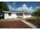 Ranch-style home exterior with a spacious backyard and shed at 1338 Whitacre Dr, Clearwater, FL 33764