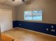 Bedroom with hardwood floors and blue accent wall at 13986 Bonnie Brae Dr, Largo, FL 33774