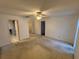 Large carpeted bedroom with ceiling fan and en-suite bathroom at 13986 Bonnie Brae Dr, Largo, FL 33774