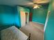 Bedroom with teal walls, carpet, and closet at 13986 Bonnie Brae Dr, Largo, FL 33774