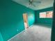 Bright bedroom with teal walls, carpet flooring, and ceiling fan at 13986 Bonnie Brae Dr, Largo, FL 33774