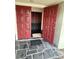 Inviting entryway with double red doors and slate tile floor at 13986 Bonnie Brae Dr, Largo, FL 33774