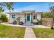 Charming bungalow with teal door, landscaping, and a walkway at 1437 Park St, Clearwater, FL 33755