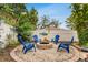 Relaxing firepit area with blue chairs in the backyard at 1437 Park St, Clearwater, FL 33755