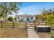 Tan house with green door and wooden fence at 1437 Park St, Clearwater, FL 33755