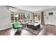 Living room with grey sofa, green chair, and hardwood floors at 1437 Park St, Clearwater, FL 33755