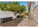 Landscaped side yard with stone pathway and seating area at 1437 Park St, Clearwater, FL 33755