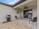 Back patio with seating area and grill at 1575 N River Cir, Tarpon Springs, FL 34689