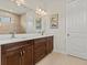 Double vanity bathroom with dark wood cabinets at 1575 N River Cir, Tarpon Springs, FL 34689