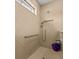 Walk-in shower with tiled walls and grab bar at 1575 N River Cir, Tarpon Springs, FL 34689