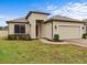 One-story house with a two-car garage and well-manicured lawn at 1575 N River Cir, Tarpon Springs, FL 34689