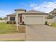 House exterior showcasing a two-car garage and landscaping at 1575 N River Cir, Tarpon Springs, FL 34689