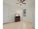 Small guest room with tiled floors, TV, and refrigerator at 1575 N River Cir, Tarpon Springs, FL 34689