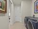 Hallway with laundry room and access to other rooms at 1575 N River Cir, Tarpon Springs, FL 34689