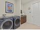 Laundry room with washer, dryer, and cabinets at 1575 N River Cir, Tarpon Springs, FL 34689