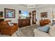 Comfortable living room featuring leather armchairs and large TV at 1575 N River Cir, Tarpon Springs, FL 34689