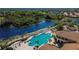 Community pool with lounge chairs and palm trees at 1649 Emerald Dunes Dr, Sun City Center, FL 33573