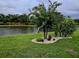 Landscaped backyard with pond and manicured lawn at 1649 Emerald Dunes Dr, Sun City Center, FL 33573