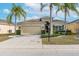 House exterior featuring a two-car garage and landscaping at 1649 Emerald Dunes Dr, Sun City Center, FL 33573