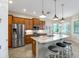 Kitchen island with seating and granite countertop at 1649 Emerald Dunes Dr, Sun City Center, FL 33573