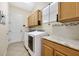 Laundry room with washer, dryer and cabinets at 1649 Emerald Dunes Dr, Sun City Center, FL 33573