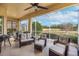 Covered patio with wicker furniture, creating a cozy space at 1649 Emerald Dunes Dr, Sun City Center, FL 33573