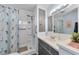 Bathroom with shower, vanity, and gray cabinets at 18675 Us Highway 19 N # 364, Clearwater, FL 33764